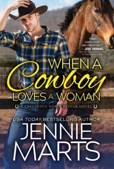 Cover for Jennie Marts · When a Cowboy Loves a Woman - Creedence Horse Rescue (Paperback Book) (2021)