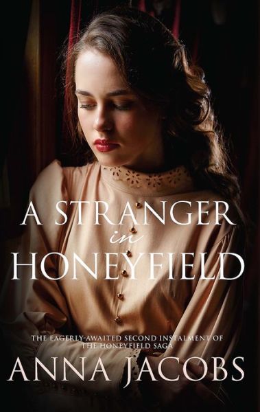 Cover for Jacobs, Anna (Author) · A Stranger in Honeyfield - The Honeyfield Series (Hardcover Book) (2016)