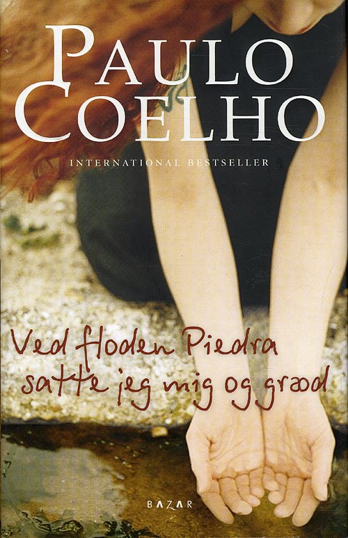 Cover for Paulo Coelho · Ved floden Piedra satte jeg mig og græd (Indbundet Bog) [1. udgave] (2009)