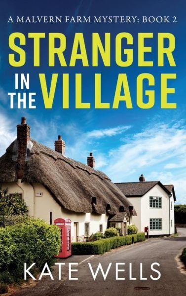 Cover for Kate Wells · Stranger in the Village: a BRAND NEW page-turning, addictive cozy mystery from Kate Wells for 2024 - The Malvern Mysteries (Hardcover Book) (2024)