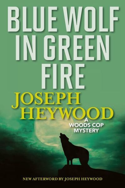 Cover for Joseph Heywood · Blue Wolf In Green Fire: A Woods Cop Mystery (Paperback Book) (2019)