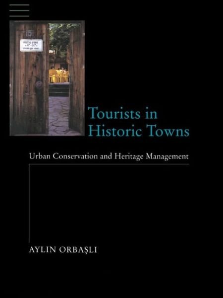 Cover for Aylin Orbasli · Tourists in Historic Towns: Urban Conservation and Heritage Management (Innbunden bok) (2016)
