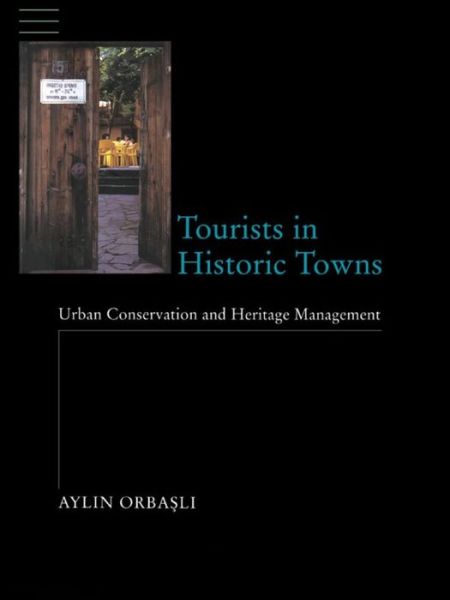 Cover for Aylin Orbasli · Tourists in Historic Towns: Urban Conservation and Heritage Management (Innbunden bok) (2016)