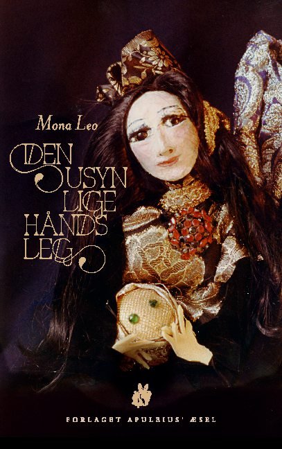 Den usynlige hånds leg - Mona Leo; Mona Leo; Mona Leo - Livres - Mikroforlaget Apuleius Æsel - 9788743019879 - 25 mars 2021